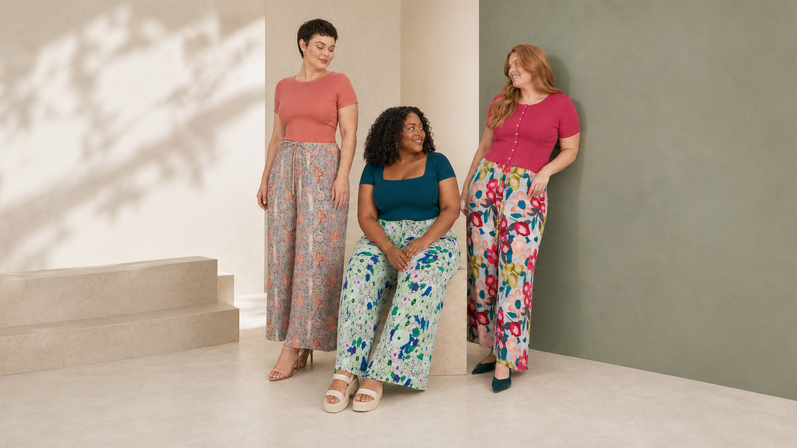 Three women styling paisley, mint botanical and large pink floral wide-leg pleated trousers.