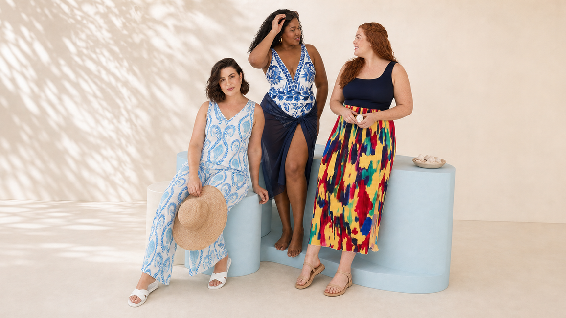 Three plus-size women in coordinated seaside blues summer looks in a natural studio scene 