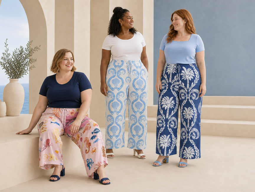 Three plus-size women wearing colourful pleated wide-leg trousers featuring ocean life, seashell and tropical palm prints with simple summer tops.