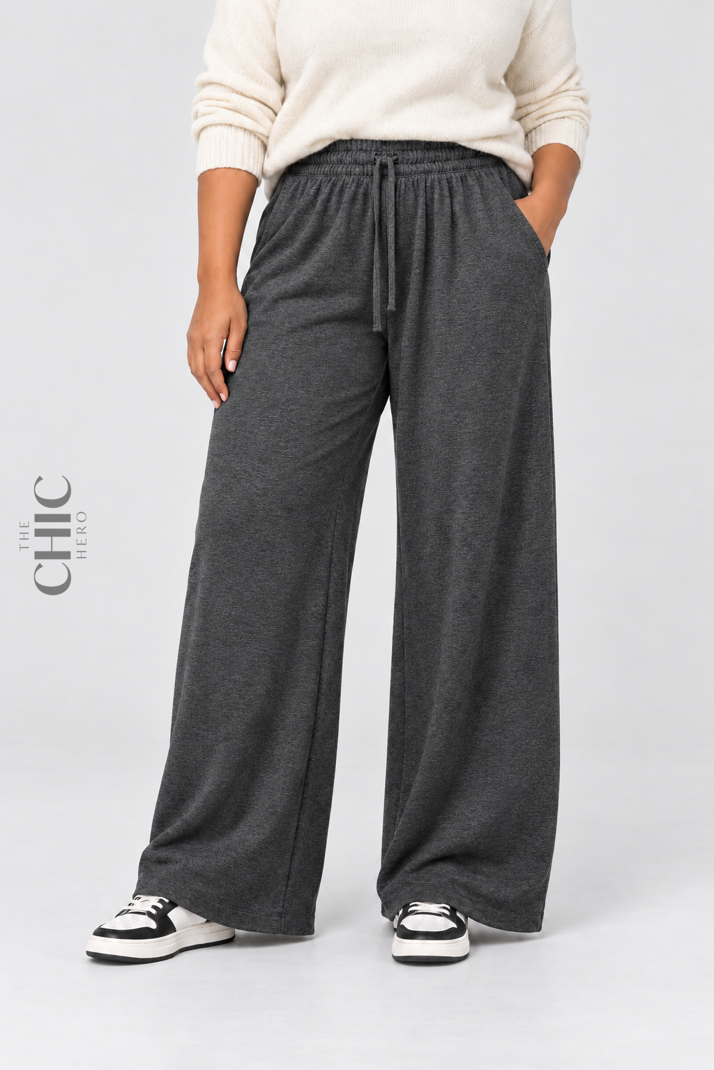Women's dark grey plus size fleece-lined wide-leg trousers styled with a cream knit top