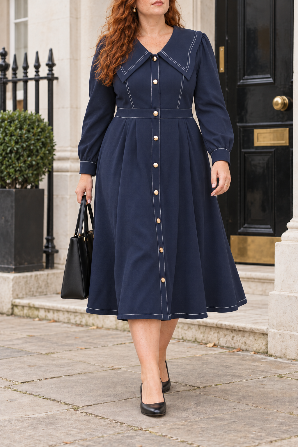 Navy contrast-stitch midi dress styled outside a British office