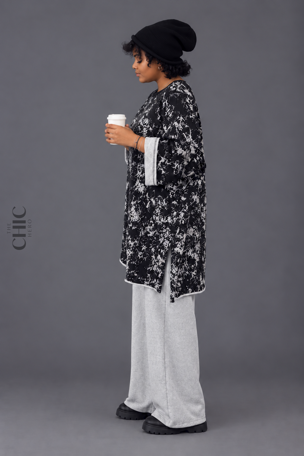 Side view of the oversized longline sweatshirt showing tummy and hip coverage with contrast turned-back cuffs