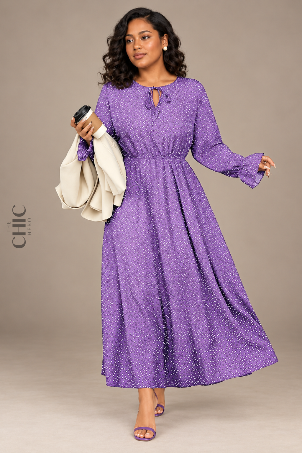 Purple polka-dot maxi dress shown in a walking pose with flowing skirt movement