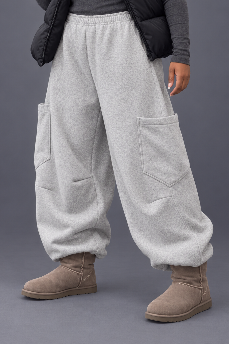 Plus size grey oversized cargo joggers shown in a relaxed studio stance