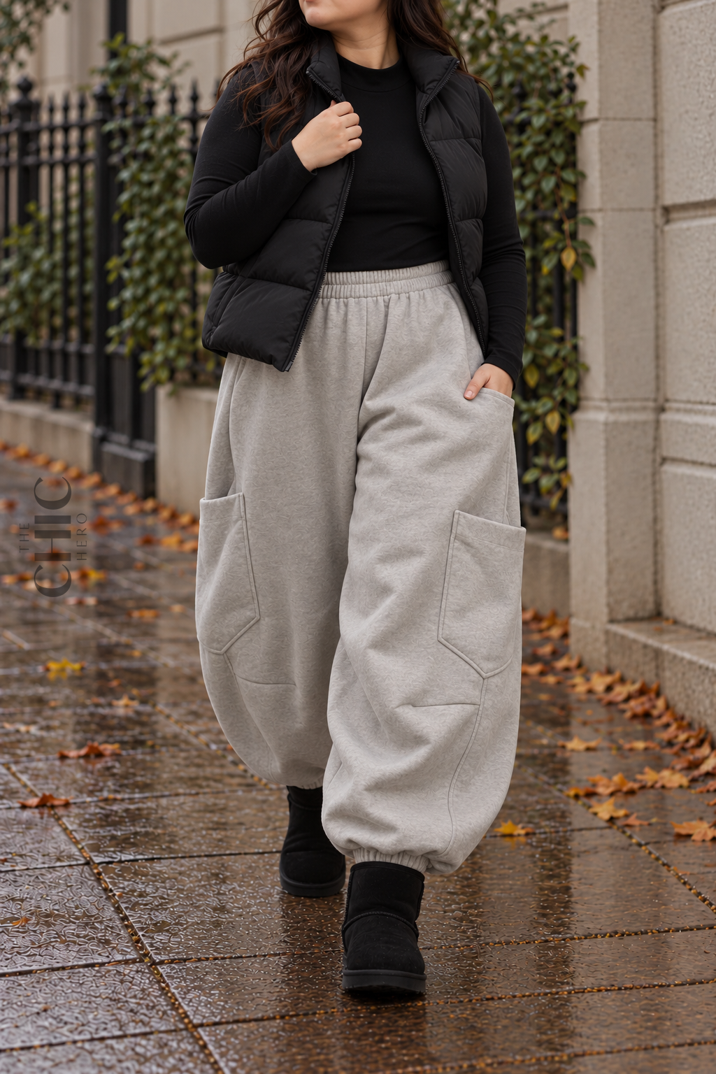 Grey extra-wide cargo joggers styled with black layers on a rainy British street