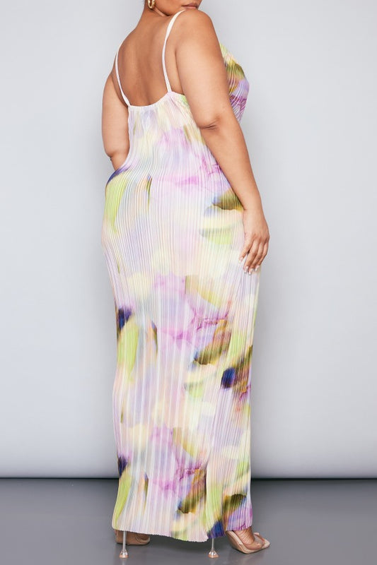 Plus size model wearing a pastel watercolour plissé cowl neck bodycon maxi dress with adjustable spaghetti straps in soft pink, lilac, green and yellow tones.