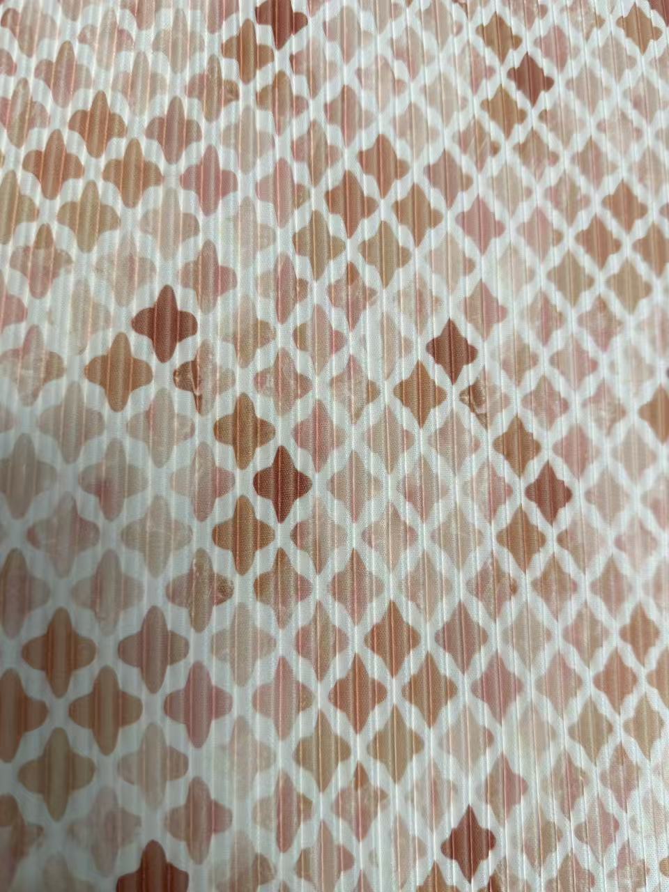 A close-up of a patterned fabric or wallpaper featuring a repeating geometric diamond lattice design in shades of terracotta, peach, and brown on a white background.