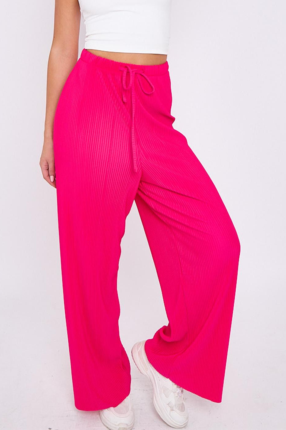 Plus size female model wearing pink magenta solid colour wide-leg drawstring palazzo pants, stretchy opaque crease-resistant fabric, sizes UK 8–32