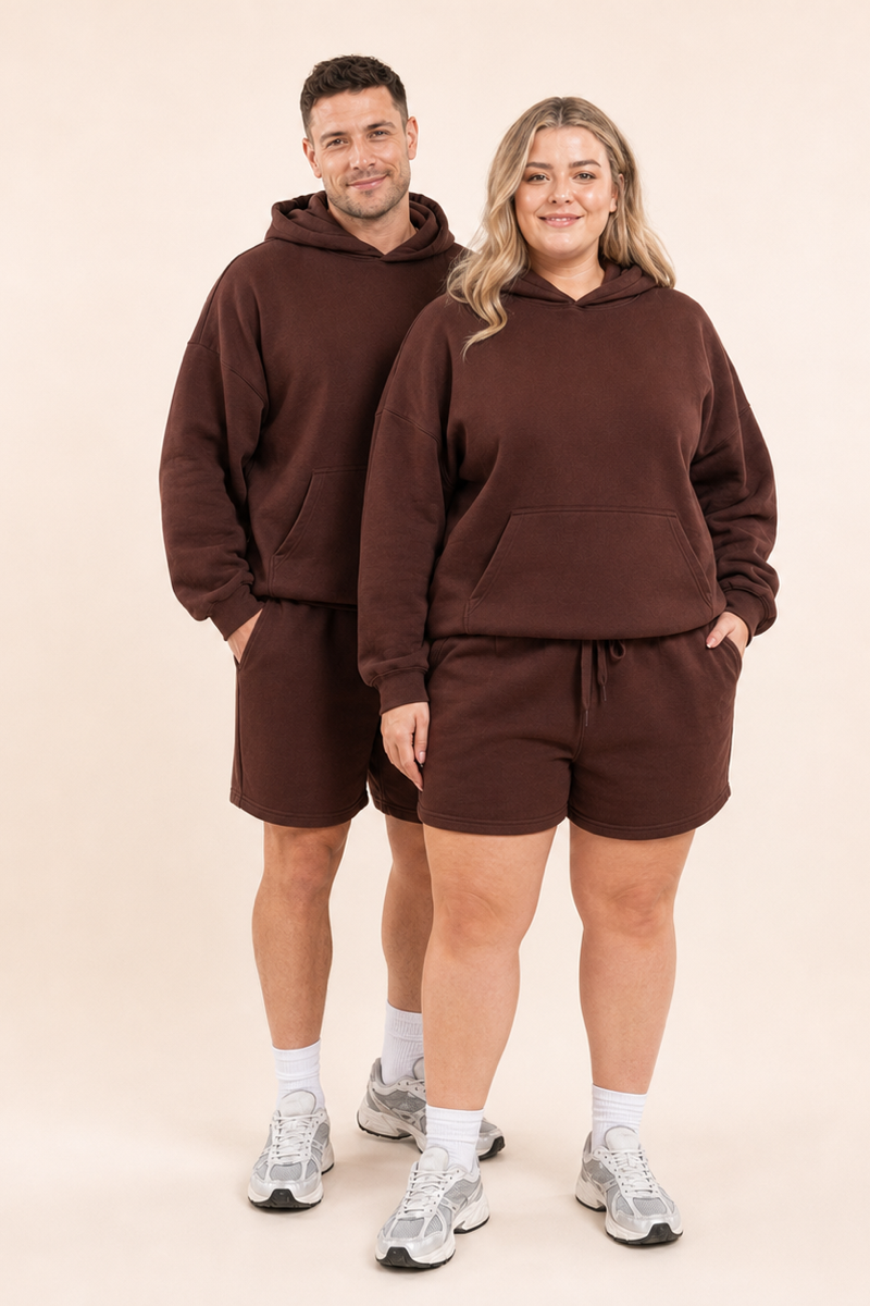 Male and female models wearing the ChicHero brown heavyweight hoodie and shorts