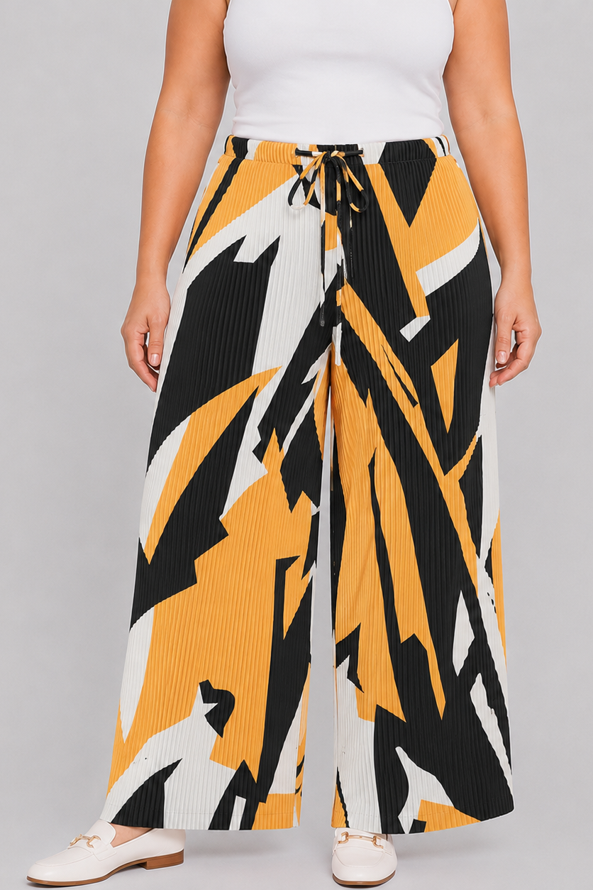 A model wearing wide-leg pleated trousers with an abstract geometric pattern in yellow, black, and white. The pants feature a drawstring waist and are styled with a white top and white flat shoes against a solid gray background.