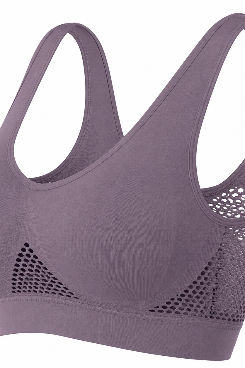 A dusty purple wireless sports bra with wide shoulder straps and breathable mesh side panels, shown on a solid white background.