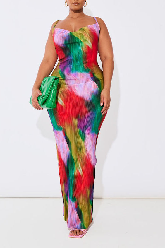 Plus size model wearing a vibrant abstract print plissé cowl neck bodycon maxi dress with adjustable spaghetti straps and a colourful summer design.