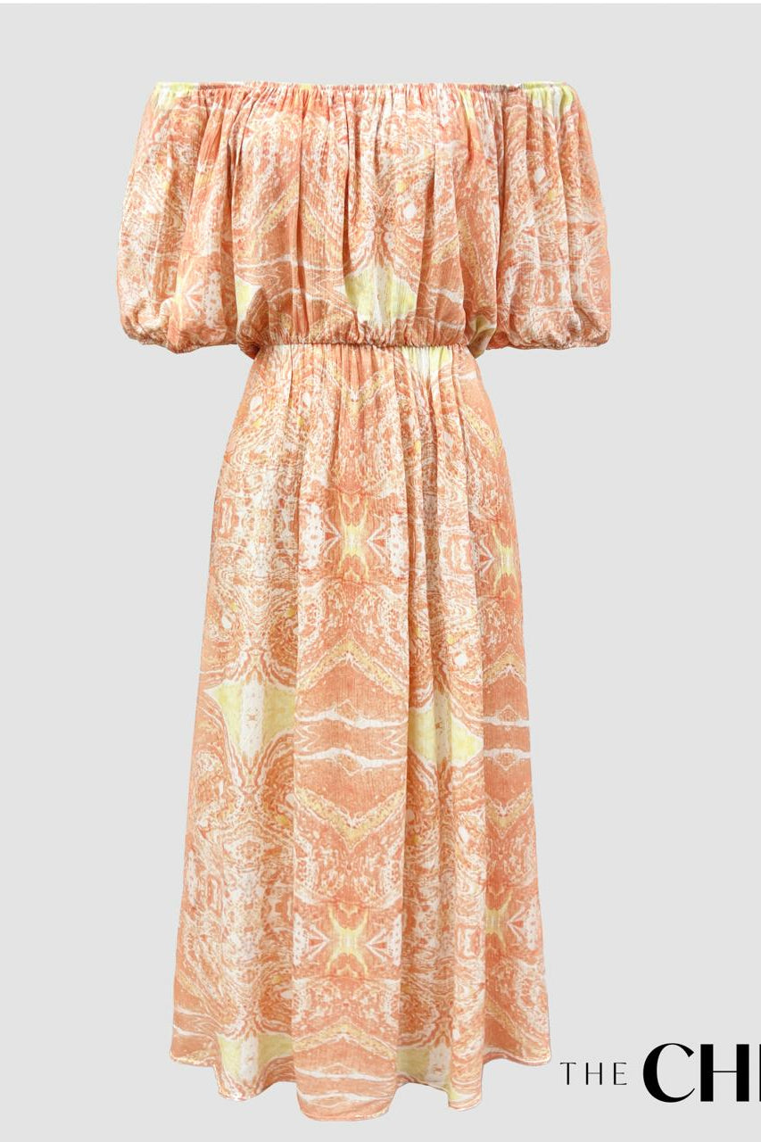 Long sleeve vintage style maxi dress in pink with a geometric pattern, displayed on a white background.