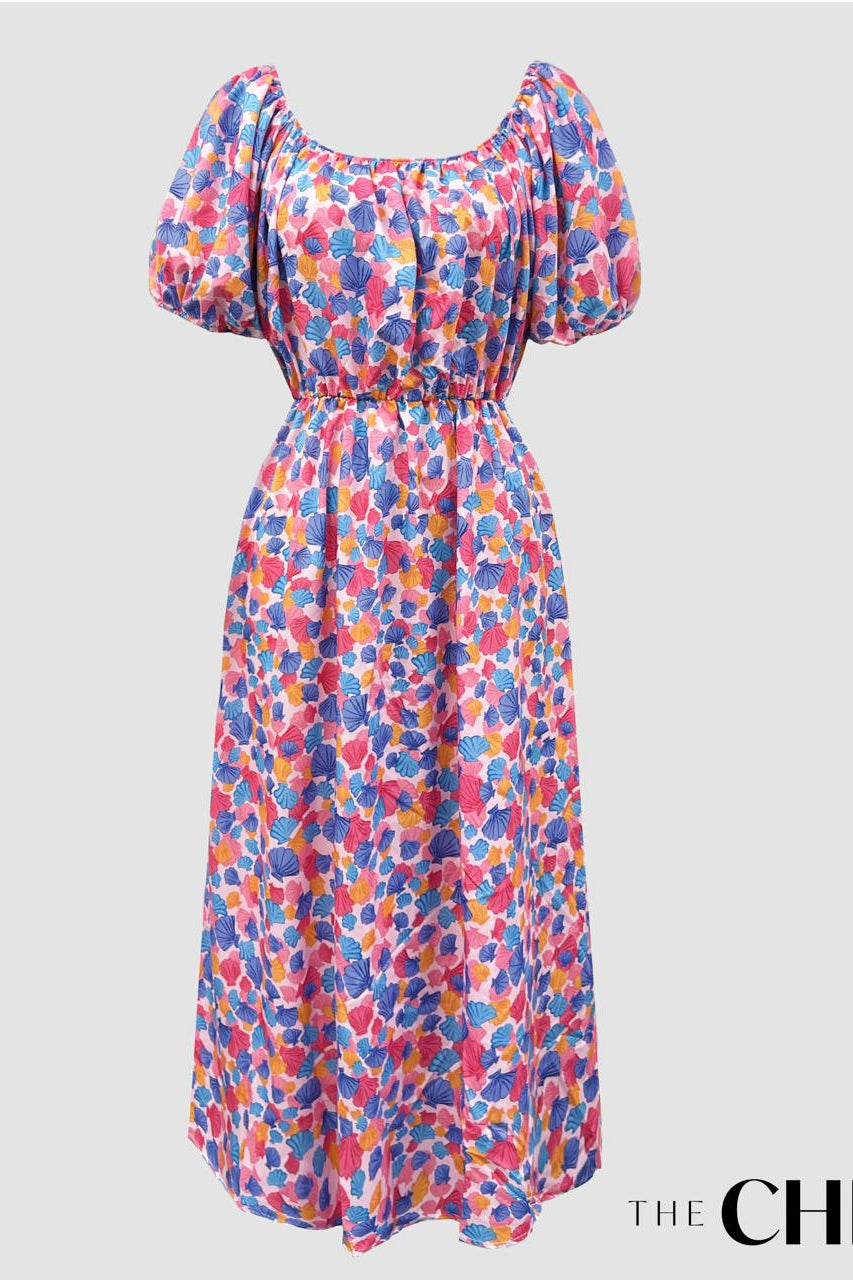 A long sleeve vintage style maxi dress with a multicolored shell print, displayed on a white background.