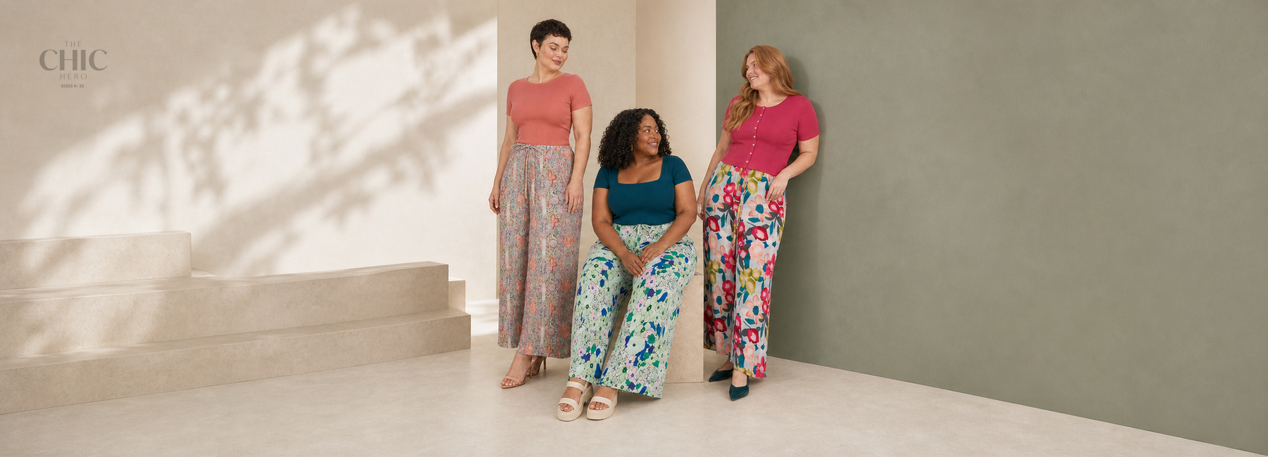 Three women styling paisley, mint botanical and large pink floral wide-leg pleated trousers.