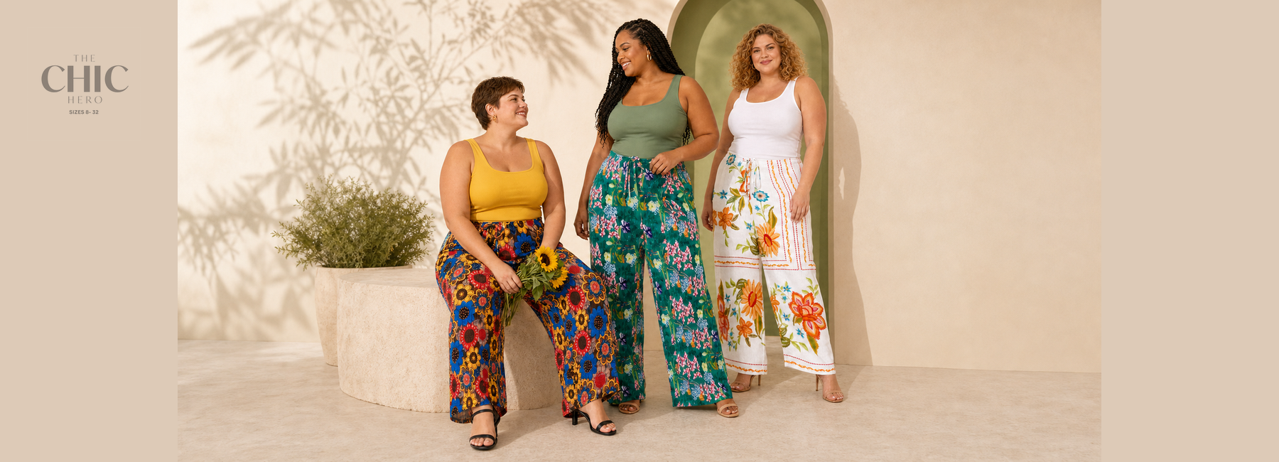 Three plus-size women wearing colourful floral pleated wide-leg trousers featuring sunflower-inspired, botanical and blooming garden prints.