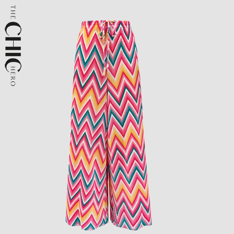 Plus size model wearing multi geometric pattern abstract print wide-leg palazzo pants, stretchy opaque crease-resistant fabric