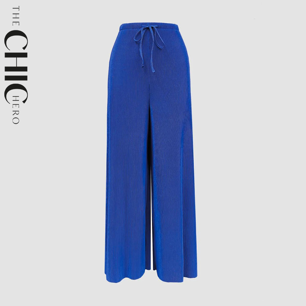Plus size female model wearing indigo chic pleated wide-leg pants, stretchy opaque crease-resistant fabric with elegant drape, sizes UK 8–32