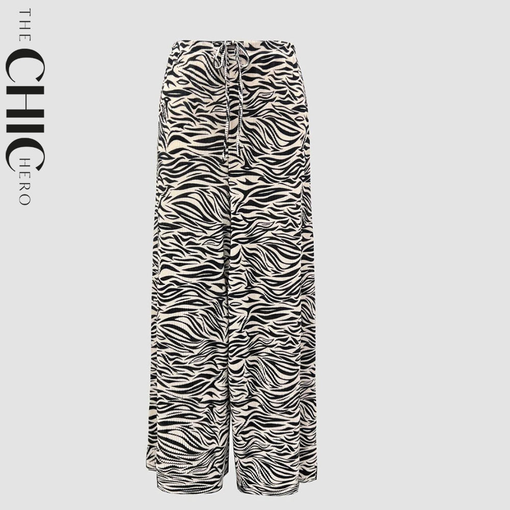Plus size model in black and white messy stripe wide-leg palazzo pants, stretchy opaque crease-resistant fabric with drawstring waist