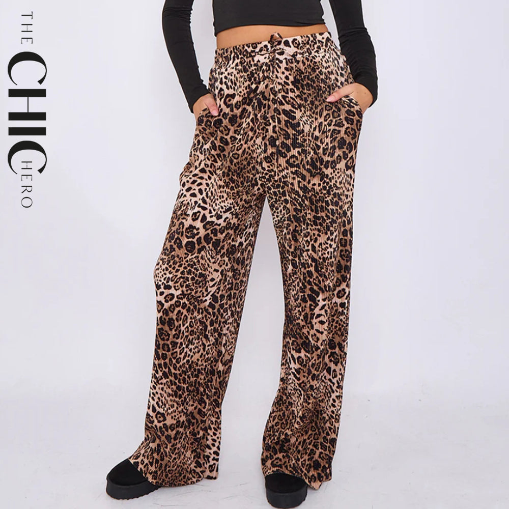 Leopard print pants worn by a person on a white background with 'The Chic Hero' branding.