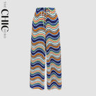 Plus size female model wearing monochrome ripple wide-leg drawstring pants with pockets, stretchy opaque crease-resistant fabric, sizes UK 8–32