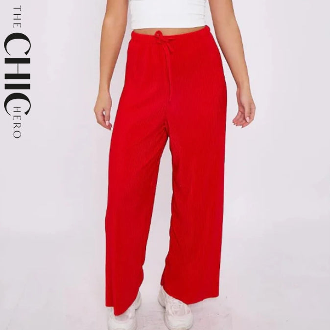 Plus size female model in red pleated palazzo pants with drawstring waist, stretchy opaque crease-resistant fabric, sizes UK 8–32