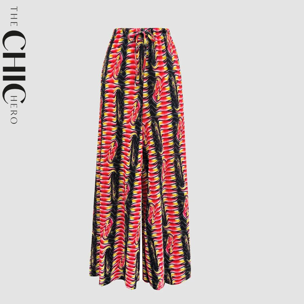 Plus size female model in red and black abstract wave print pleated palazzo pants, stretchy opaque crease-resistant fabric with drawstring waist