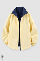 Butter Yellow and Navy unisex reversible oversized windproof jacket, front product view.