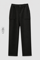Plus size black fleece-lined relaxed trousers with double-button waist and patch pockets, front view