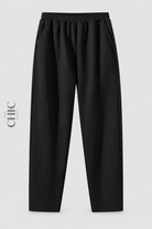 Front view of women's plus size black pull-on straight-leg trousers with an elasticated waist and side pockets