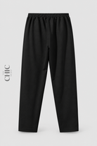 Back view of women's plus size black pull-on straight-leg trousers with a plain elasticated waist