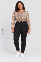 Black plus size high-rise stretch pencil trousers styled with a plaid shirt and white trainers