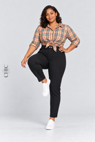 MODEL-03 demonstrating comfortable movement in black high-rise stretch pencil trousers with a natural front knee lift