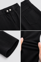 Double-button waist, back pocket, ankle hem and stretch-fabric details of black pencil trousers