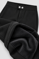 Black fleece-lined stretch pencil trousers showing the soft brushed inner layer