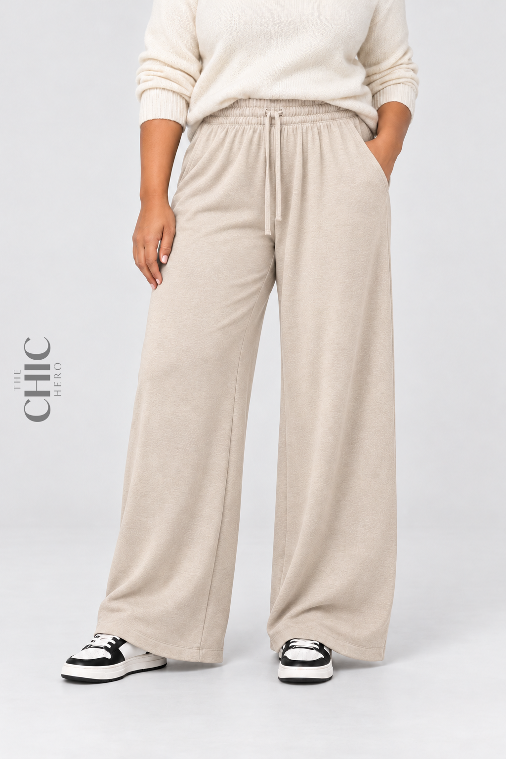 Women's beige plus size fleece-lined wide-leg trousers styled with a cream knit top