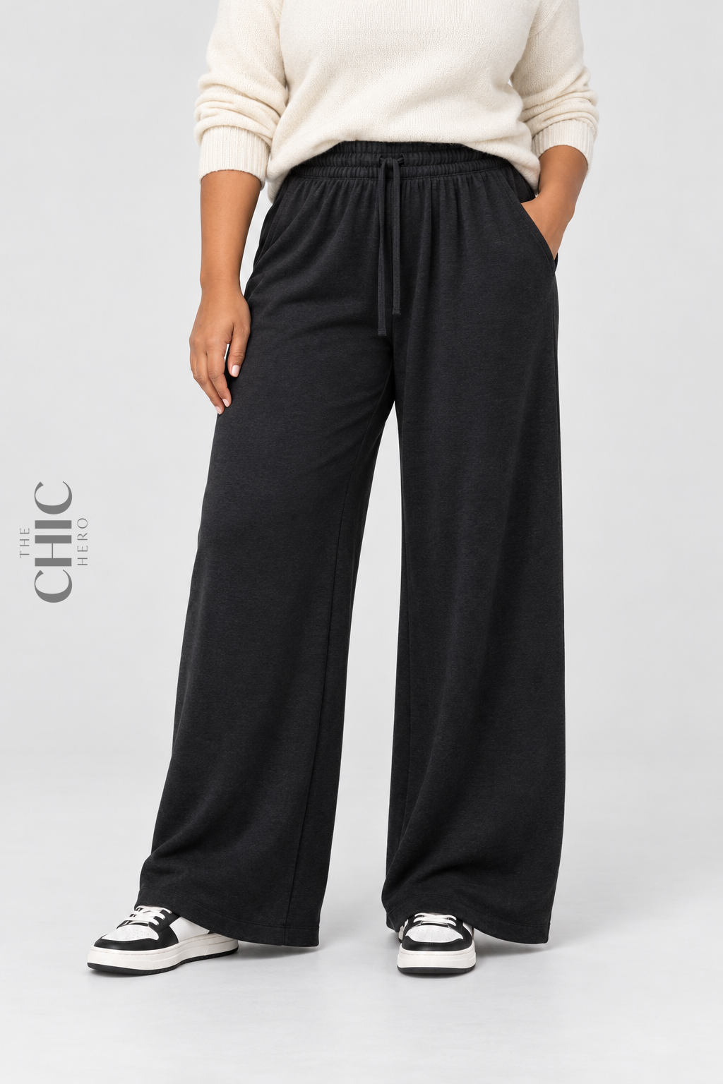 Women's black plus size fleece-lined wide-leg trousers styled with a cream knit top