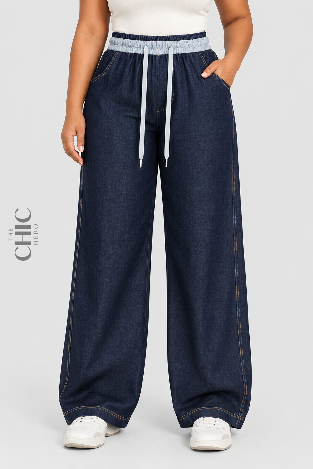 The Chic Hero denim blue wide-leg drawstring trousers front view on a plus size model