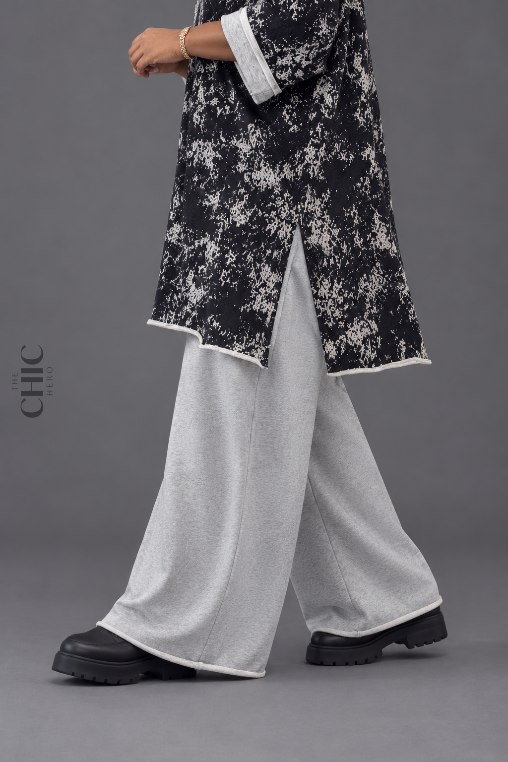 Close view of the abstract print longline sweatshirt side slit and pale contrast edge detail