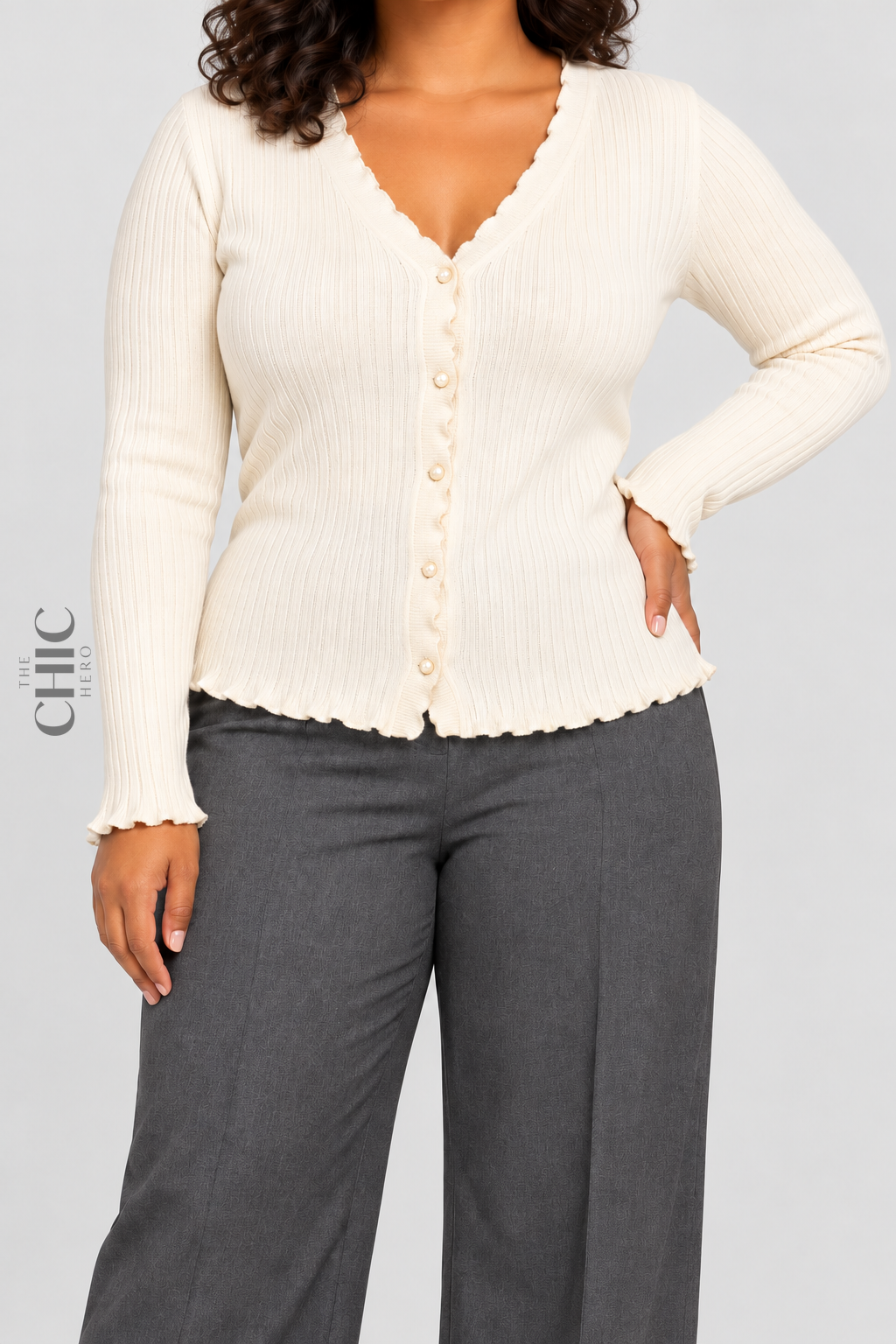 Cream V-neck ruffle-trim cardigan styled with grey trousers