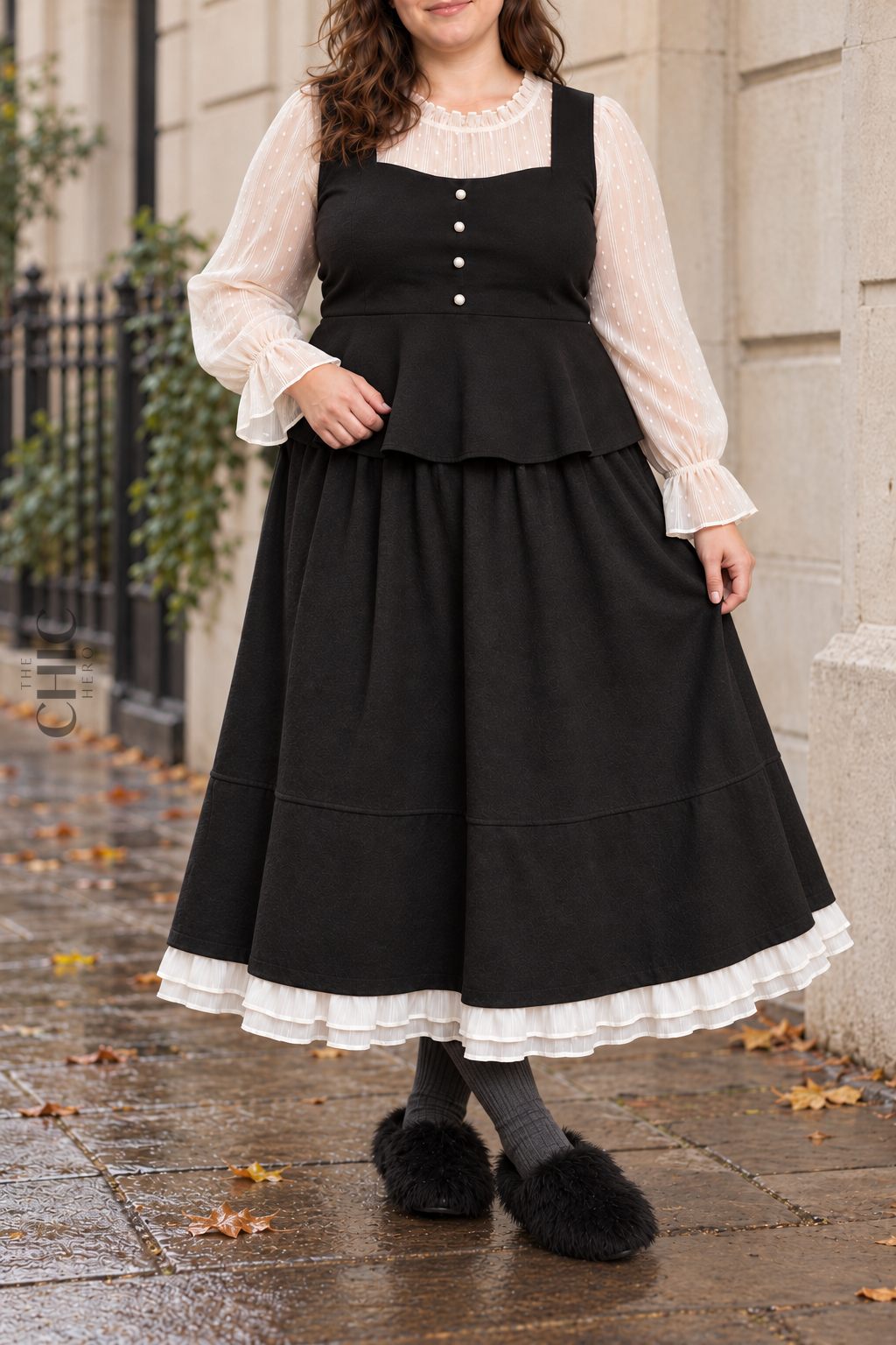 Black ruffle-hem maxi skirt shown in a different standing pose on a plus size model