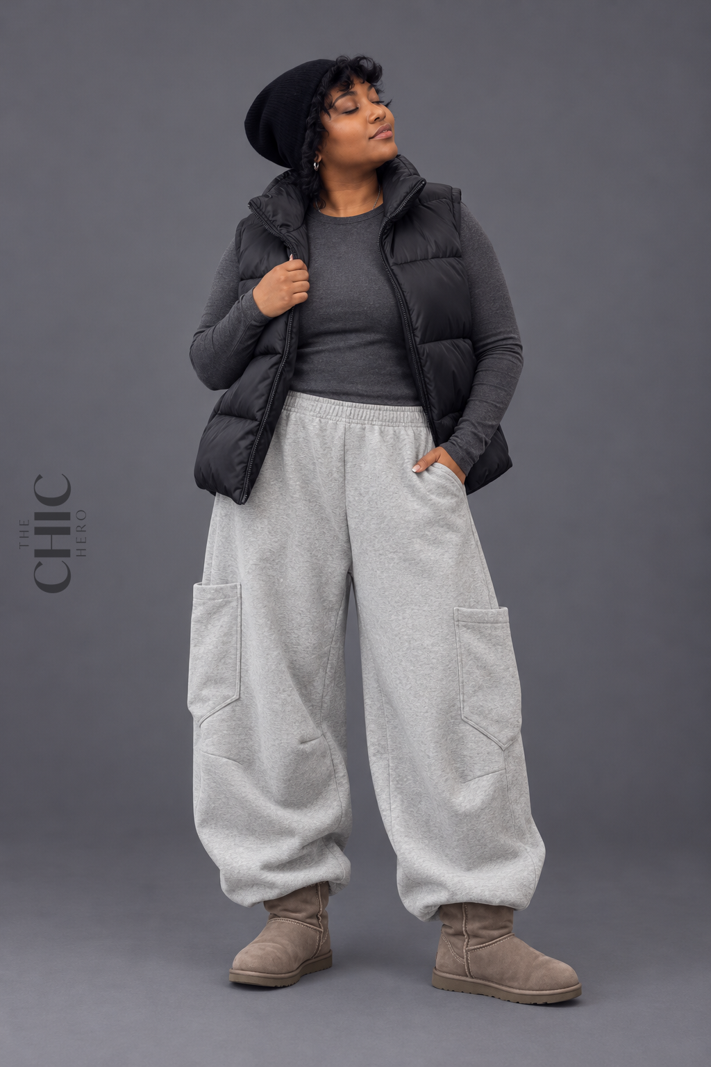 Grey extra-wide barrel-leg cargo joggers on a plus size model in a cool studio look