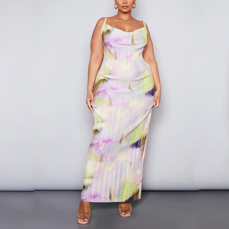 Plus size model wearing a pastel watercolour plissé cowl neck bodycon maxi dress with adjustable spaghetti straps in soft pink, lilac, green and yellow tones.