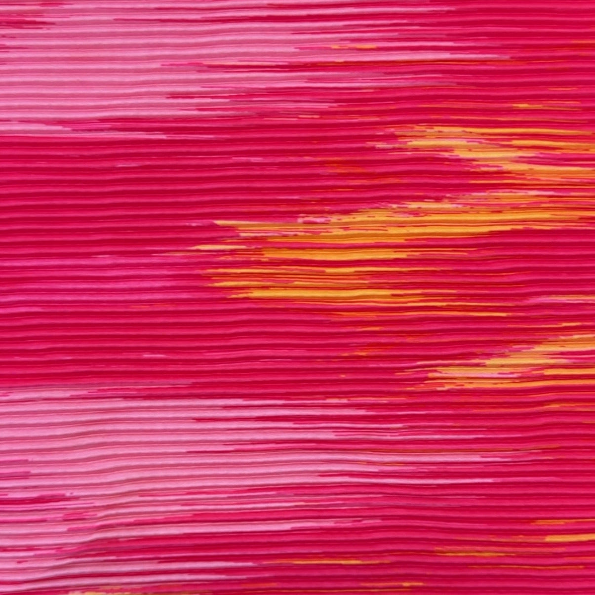 A close-up of a textured fabric pattern featuring horizontal brushstroke-like lines in vibrant magenta pink with accents of orange and yellow.
