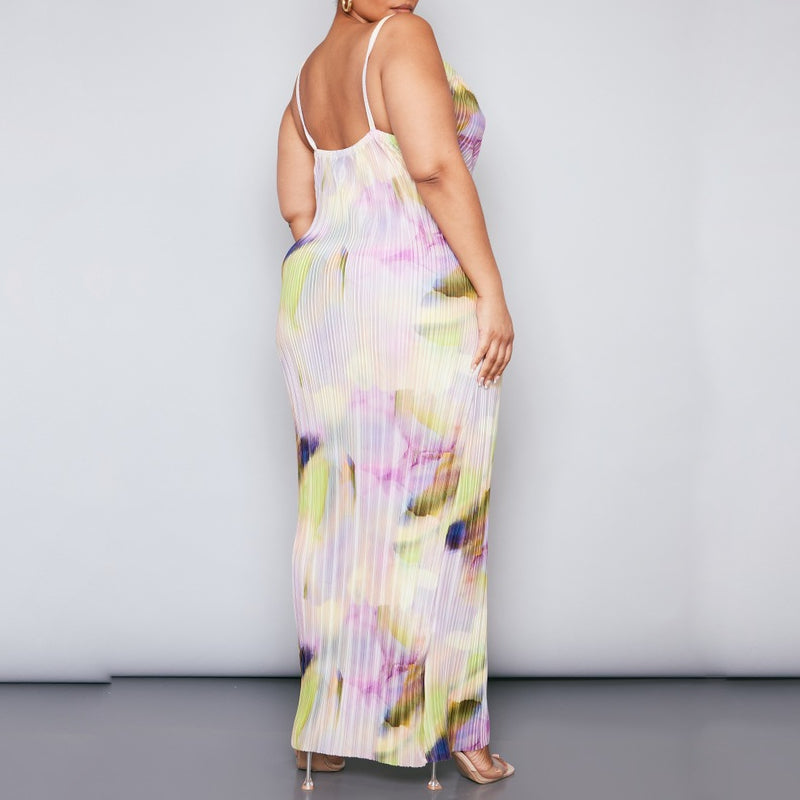 Plus size model wearing a pastel watercolour plissé cowl neck bodycon maxi dress with adjustable spaghetti straps in soft pink, lilac, green and yellow tones.