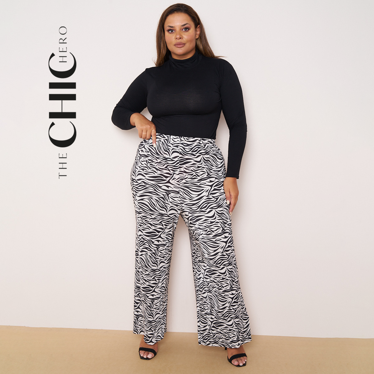 Plus size model in black and white messy stripe wide-leg palazzo pants, stretchy opaque crease-resistant fabric with drawstring waist
