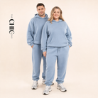 Male and female models wearing the ChicHero blue heavyweight hoodie and joggers