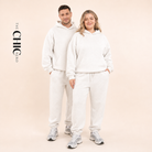 Male and female models wearing the ChicHero white heavyweight hoodie and joggers