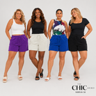 Four women modeling matching lounge sets consisting of a tank top and drawstring shorts in different colorways: purple and white, cream and white, royal blue and multicolor, and black and black. The image is set against a plain light gray studio background with a logo in the bottom right corner that reads 'THE CHIC HERO SIZES 8-32'.