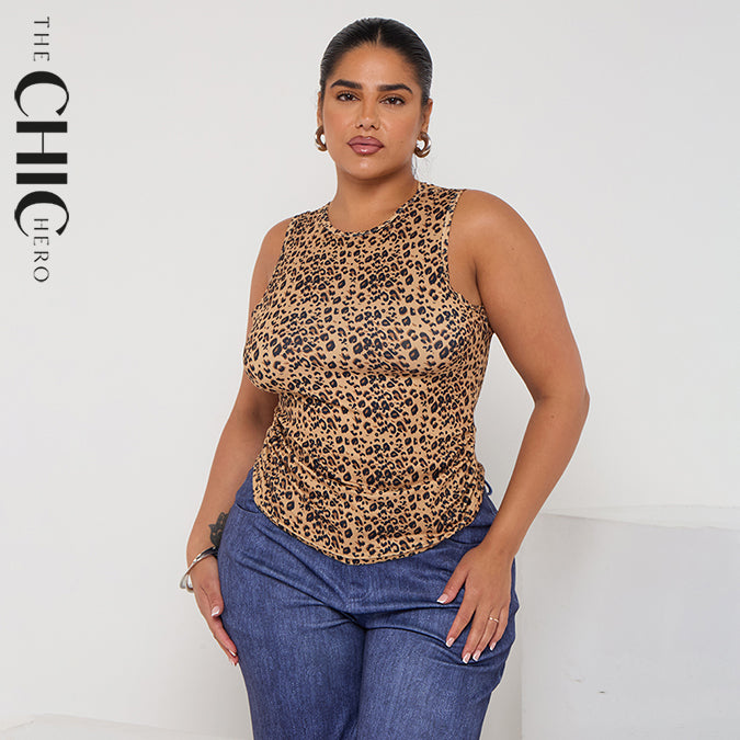 Woman wearing a leopard print top and blue jeans with 'The Chic Hero' branding.